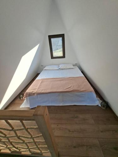 a bedroom with a bed in a attic at RanyA-Frame in Nucşoara