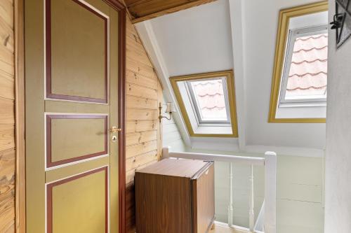 a staircase with a wooden door and a wooden box at City Center Gem I Traditional Bergen Style in Bergen