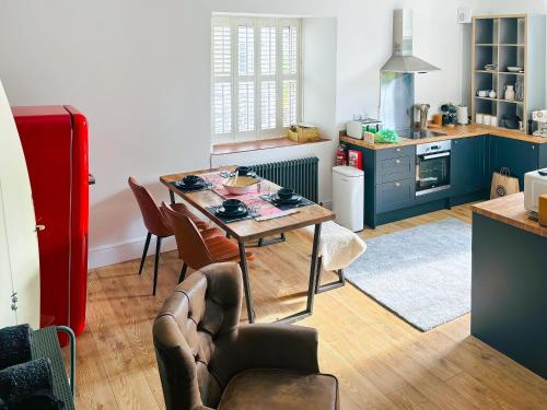 a kitchen with a table and chairs in a room at Bolingey Chapel in Perranporth