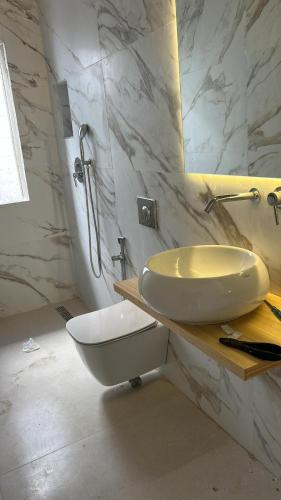 a white bathroom with a sink and a mirror at Villa Jasmin 12 in M'diq