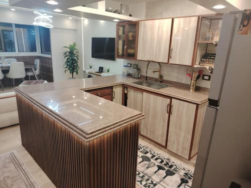 a kitchen with a large island in the middle at Apartment with panoramic sea view sidi bshr Families only in Alexandria