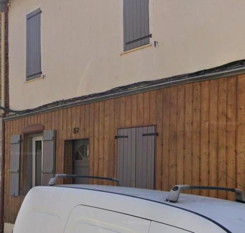 a white car parked in front of a building at Le chalet romantique, SPA, Écran cinéma, Lit king size, day use, 10 min centre in Amiens