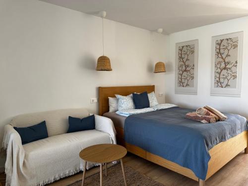 a bedroom with a bed and a couch at Sunny Sea Garden Apartment in Mijas Costa