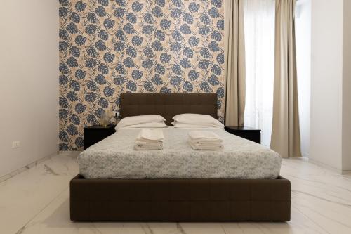 a bedroom with a bed with two towels on it at Domus Suite in Termoli