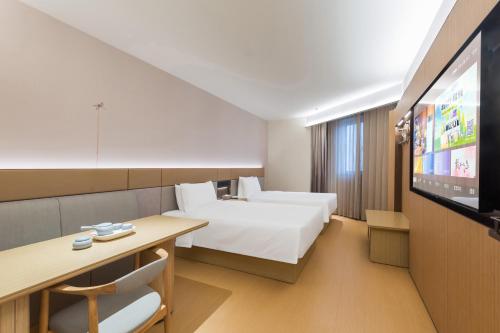 Cama o camas de una habitación en Ji Hotel Beijing Fangshan District Goverment