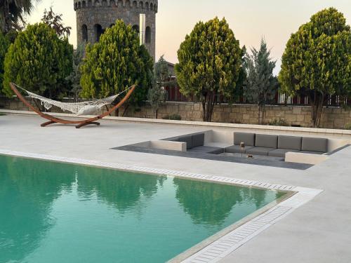 a hammock sitting next to a pool of water at Green Acre Villa in Karteros