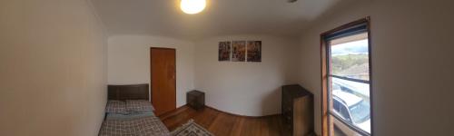 a room with two beds and a large window at Room with King Single bed in Melbourne