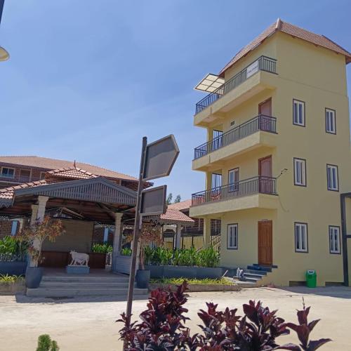 a building with a sign in front of it at Hasiru Bhoomi Resort 
