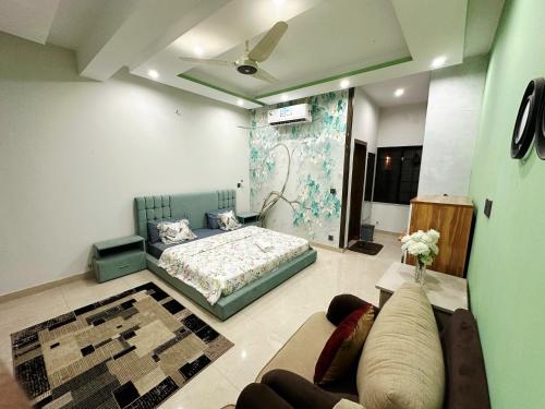 a living room with a bed and a couch at AAA Guest House in Rawalpindi