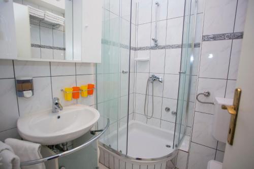 a bathroom with a shower and a sink and a shower at Villa Ankora Apartments Tučepi in Tučepi