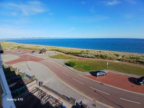 a view of a road next to the ocean at Sea View Double 1st Floor in Pwllheli