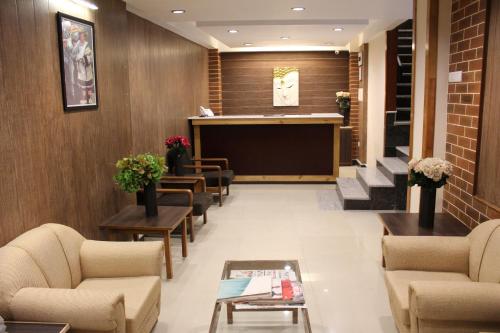 a waiting room with couches and a podium in a building at Hotel Orchid in Gangtok