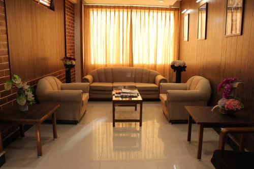 a large living room with couches and a table at Hotel Orchid in Gangtok
