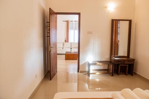 a living room with a door leading into a living room at The Teak Ambalangoda in Ambalangoda