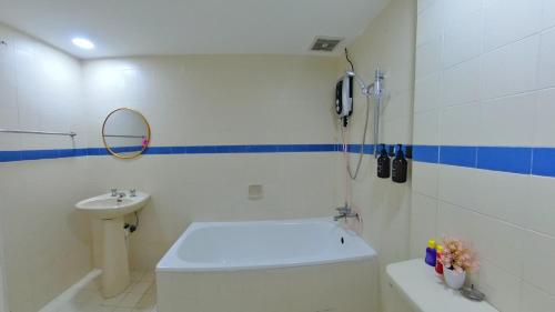 a bathroom with a toilet and a sink at 4-10pax BAYU BEACH 2R2B PRIVATE BEACH, WATERSPORT, Pool, Bbq, Wifi, 50"TV in Port Dickson