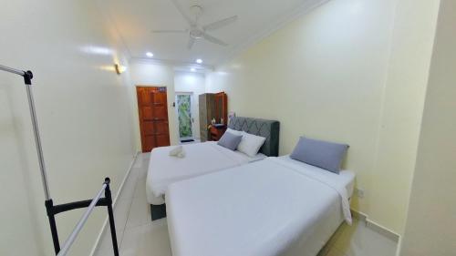 a white room with two beds in it at 4-10pax BAYU BEACH 2R2B PRIVATE BEACH, WATERSPORT, Pool, Bbq, Wifi, 50"TV in Port Dickson