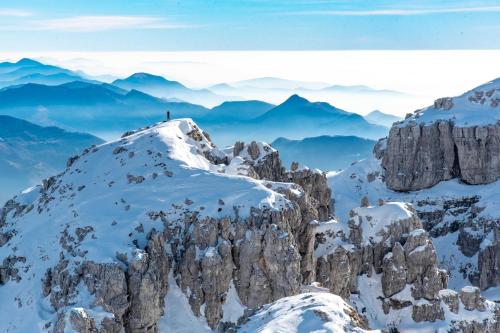 a person standing on top of a mountain in the snow at Shackleton Chalet in Sestriere