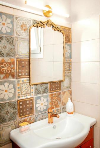 a bathroom with a sink and a mirror at Liopetra in Serres