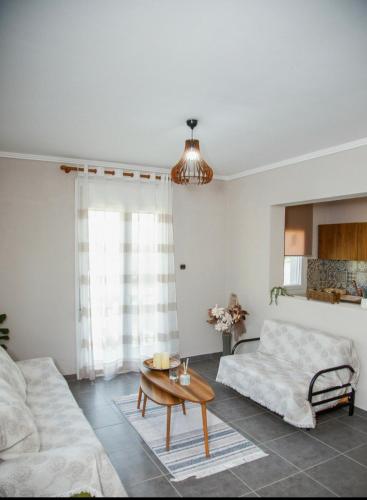 a living room with a couch and a coffee table at Liopetra in Serres