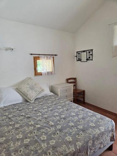 a bedroom with a bed and a dresser and a window at Saignon, Chambres d hôtes in Saignon