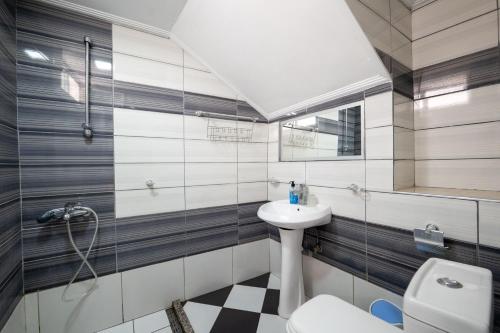 a bathroom with a sink and a toilet at Andy Apartments in Sarandë