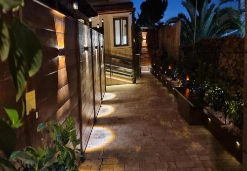 a walkway with lights on the side of a house at Taras Di San Vito Guest House in Taranto