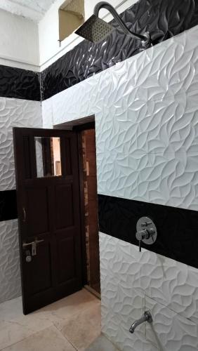 a bathroom with a black and white wall at Castle View Haveli in Jodhpur