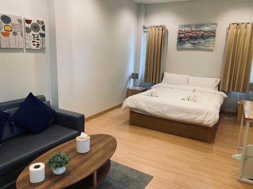 a living room with a bed and a couch at Pani House in Ban Nong Chaeng