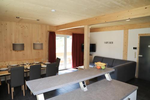 a dining room with a table and chairs at Woody Park Feriendorf Murau in Murau