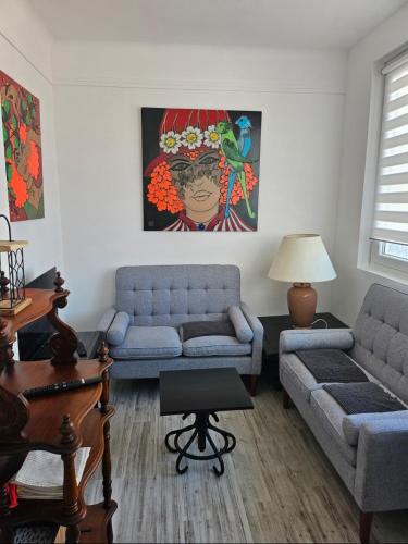 a living room with two couches and a table at La Marée in Calais