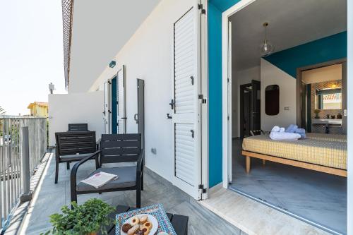 a bedroom with a bed on a balcony at Affittacamere Marizzola in Cala Gonone