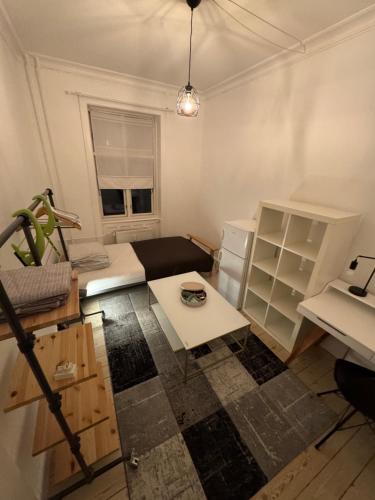 a small room with a bed and a table at Nordhavn Cozy Room in shared apartment in Copenhagen