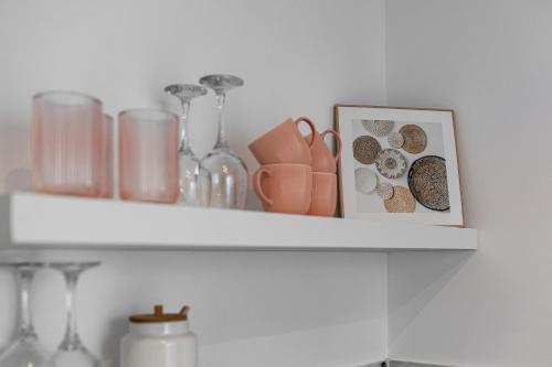 a shelf with vases and a picture on it at Forest Edge Retreat in Lupeni