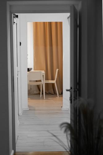 an open door to a room with a table and a chair at Forest Edge Retreat in Lupeni