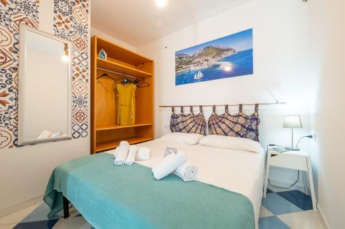 a bedroom with a bed and a mirror at Monolocale Marizzola in Cala Gonone