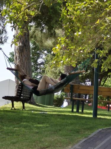 a woman laying in a hammock in a park at Shoresh Green Hills in Shoresh