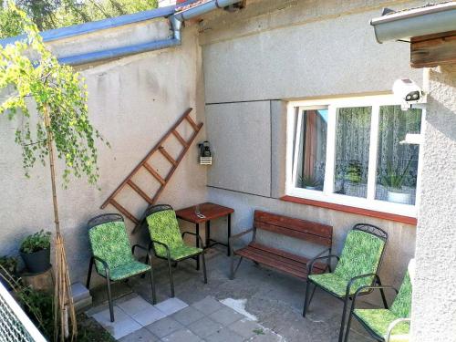 a patio with chairs and a bench and a table at Chalupa pod Zámkem in Plumlov