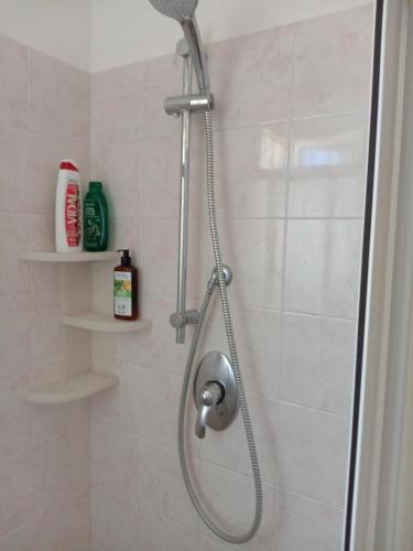 a shower with a shower head in a bathroom at Camera matrimoniale con bagno in Castellana Grotte