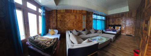 a living room with couches and windows in a train at Shivaay guest house in Tosh
