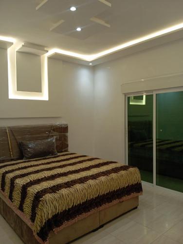 a bedroom with a large bed in a room at Appartement a Oued laou complexe cité cinter in Oued Laou