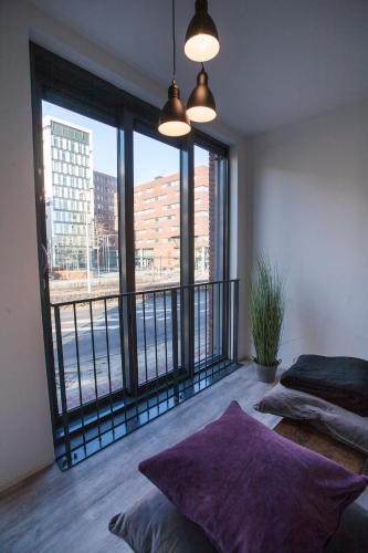 a bedroom with a balcony with a view of a city at Apartment 4G in Amersfoort