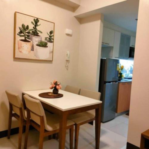 a kitchen with a table and chairs and a kitchen with a refrigerator at One Manchester Place in Punta Engaño