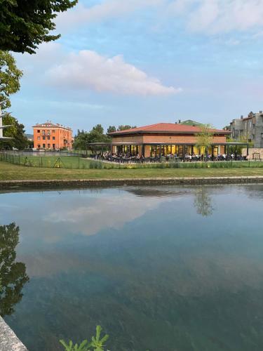 a building next to a large body of water at La casa ai Laghetti in Montorio Veronese
