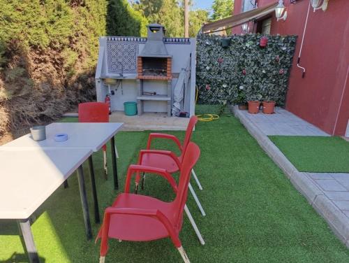 a backyard with a table and chairs and a grill at Apartamentos Camping El Palmar in El Palmar