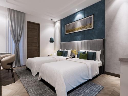 two beds in a hotel room with a wall at Solace Suites Hotel & Banquets in Barog