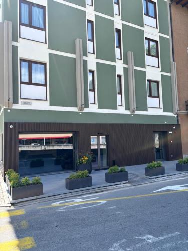 a large building with a street in front of it at Hotel Stelvio Tirano in Tirano