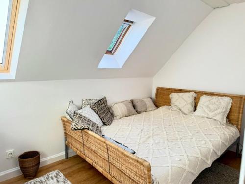 a bedroom with a wicker couch in a attic at Lake Balaton Panorama Mansion in Révfülöp