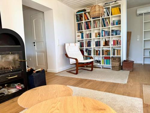a living room with a book shelf filled with books at Lake Balaton Panorama Mansion in Révfülöp