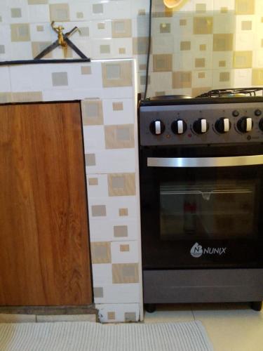 a kitchen with a stove and a counter top at Stays with Fred in Ruiru