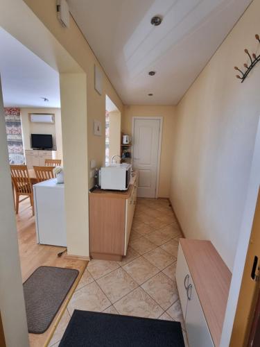 a room with a kitchen and a living room at Pylimo 59 in Šventoji
